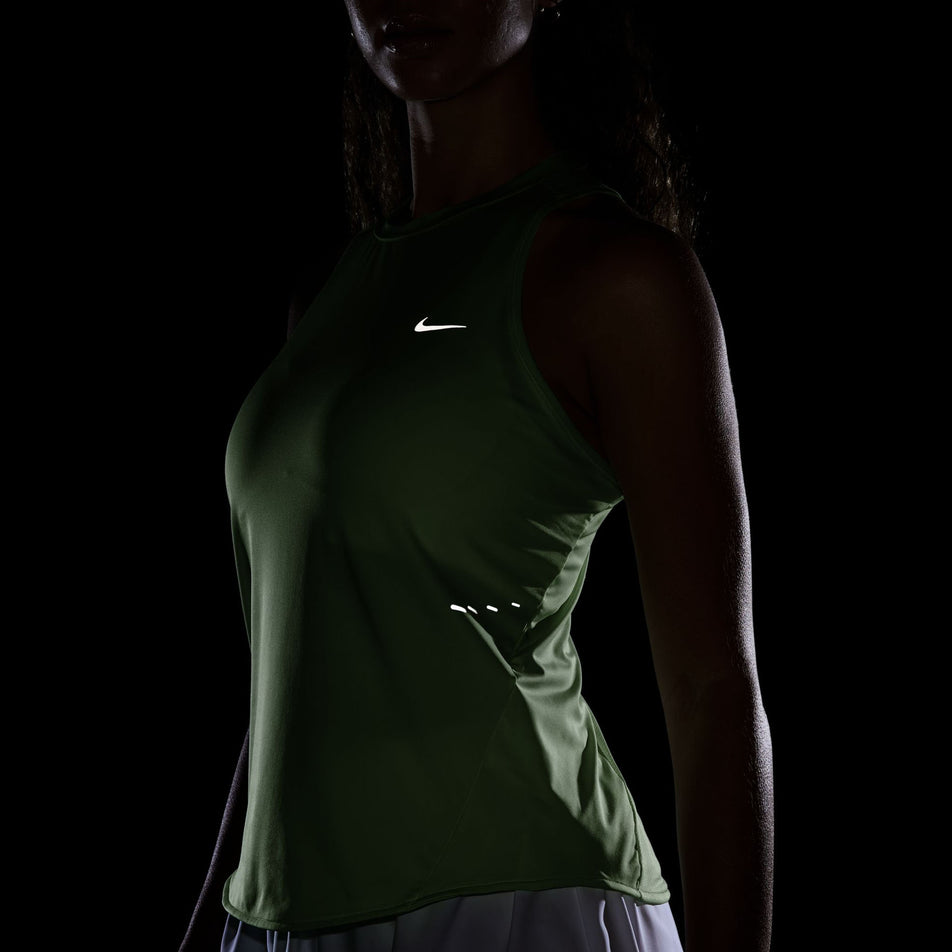 The reflective Swoosh on the front of the Nike Women's Swift Dri-FIT Running Tank Top in the Barely Volt/Reflective Silver colourway. (8620142952610)