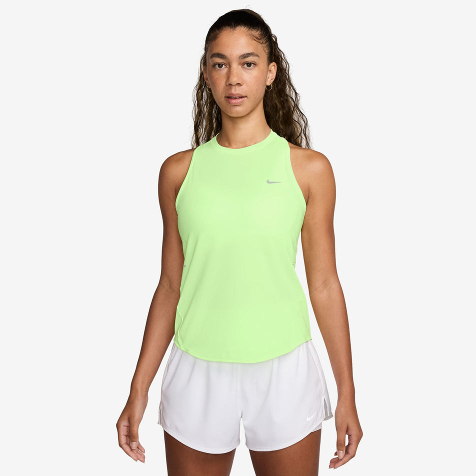 Front view of a model wearing the Nike Women's Swift Dri-FIT Running Tank Top in the Barely Volt/Reflective Silver colourway. (8620142952610)
