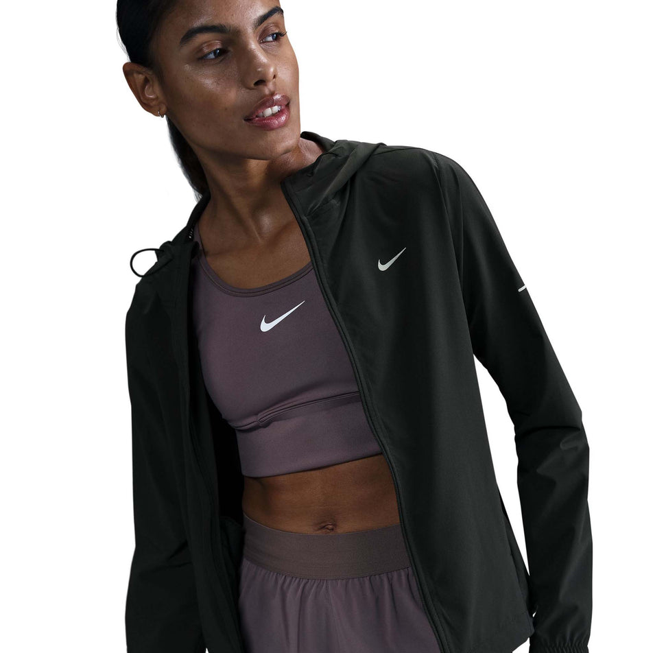Front view of a model wearing a Nike Women's Swift Repel Packable Running Jacket in the Black/Reflective Silver colourway. (8560817635490)