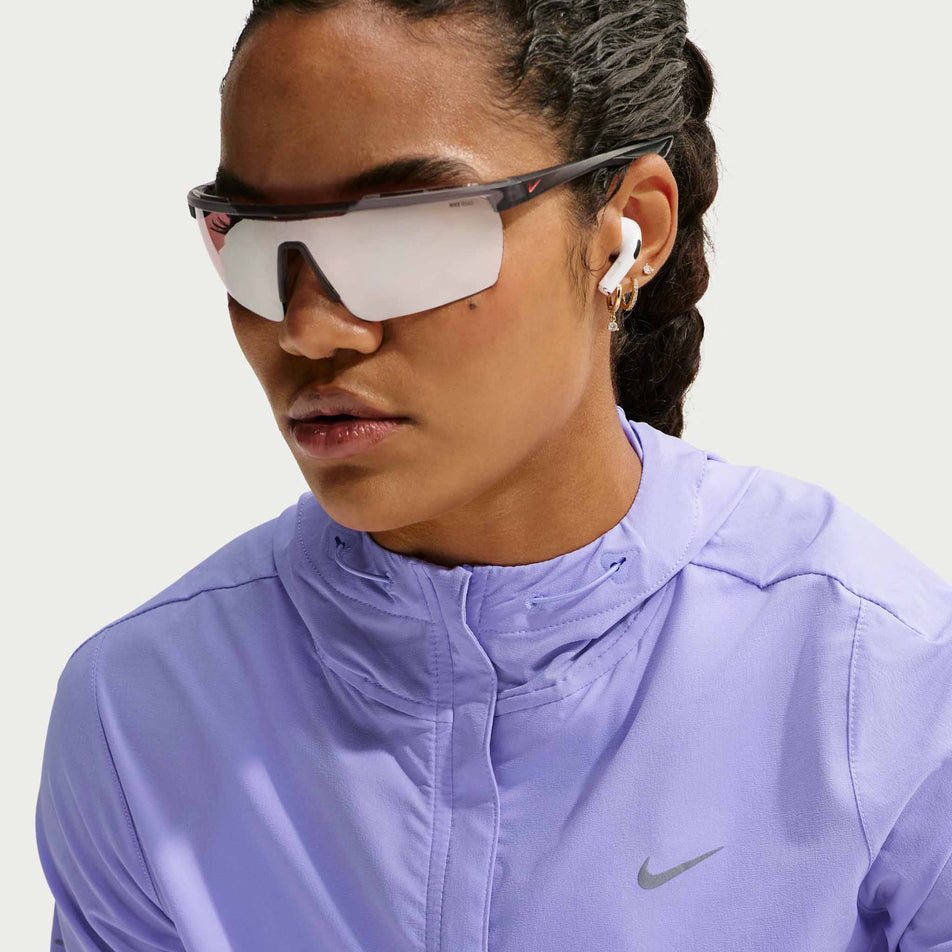 Front view of a model wearing the Nike Women's Swift Repel Packable Running Jacket in the Purple Pulse/Reflective Silver colourway.