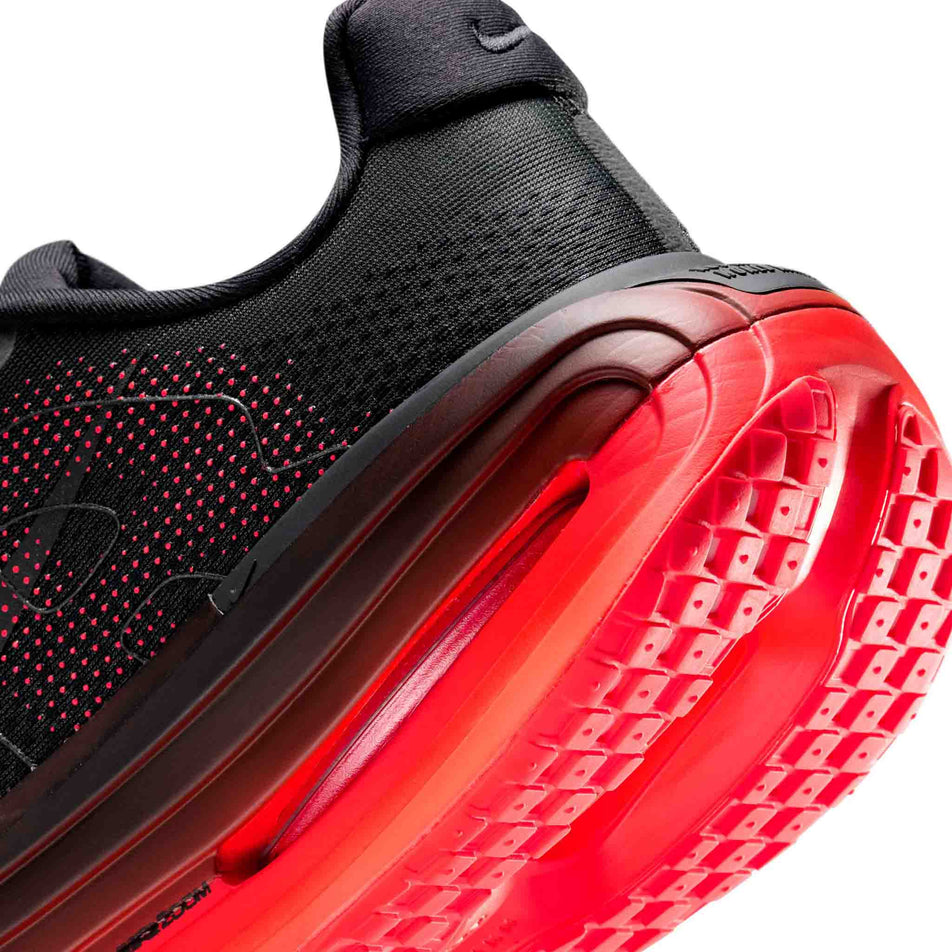 Close-up view of the rearfoot section of the left shoe from a pair of Nike Men's Vomero Premium Road Running Shoes in the Black/Black-Bright Crimson colourway.