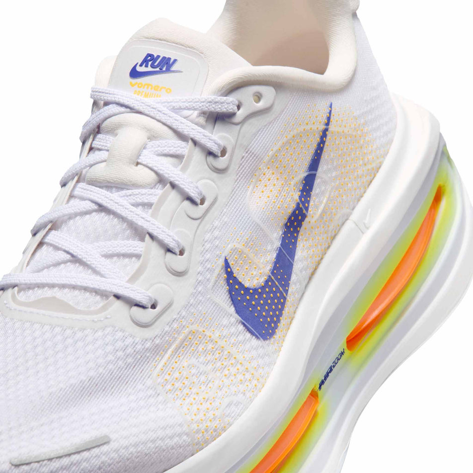Close-up view of the left shoe from a pair of Nike Men's Vomero Premium Road Running Shoes in the White/Lapis-Total Orange-Laser Orange colourway.