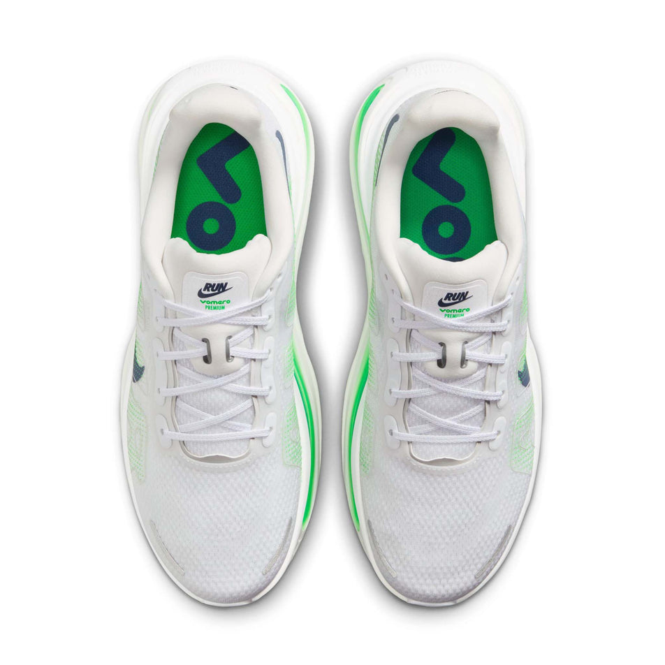 The uppers of a pair of Nike Men's Vomero Premium Road Running Shoes in the White/Midnight Navy-Green Spark colourway.