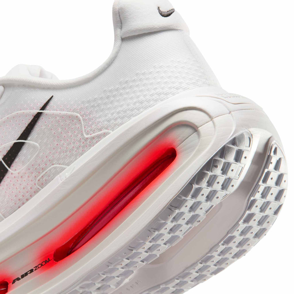Close-up view of the rearfoot section of the left shoe from a pair of Nike Men's Vomero Premium Road Running Shoes in the White/Black-Bright Crimson-Photon Dust colourway.