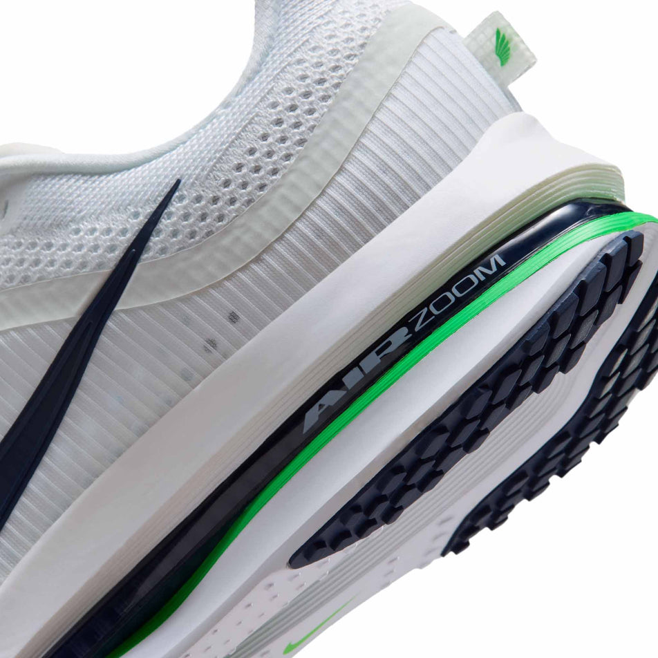 Close-up view of the rearfoot section of the left shoe from a pair of Nike Men's Pegasus Premium Road Running Shoes in the White/Green Spark-Midnight Navy colourway.
