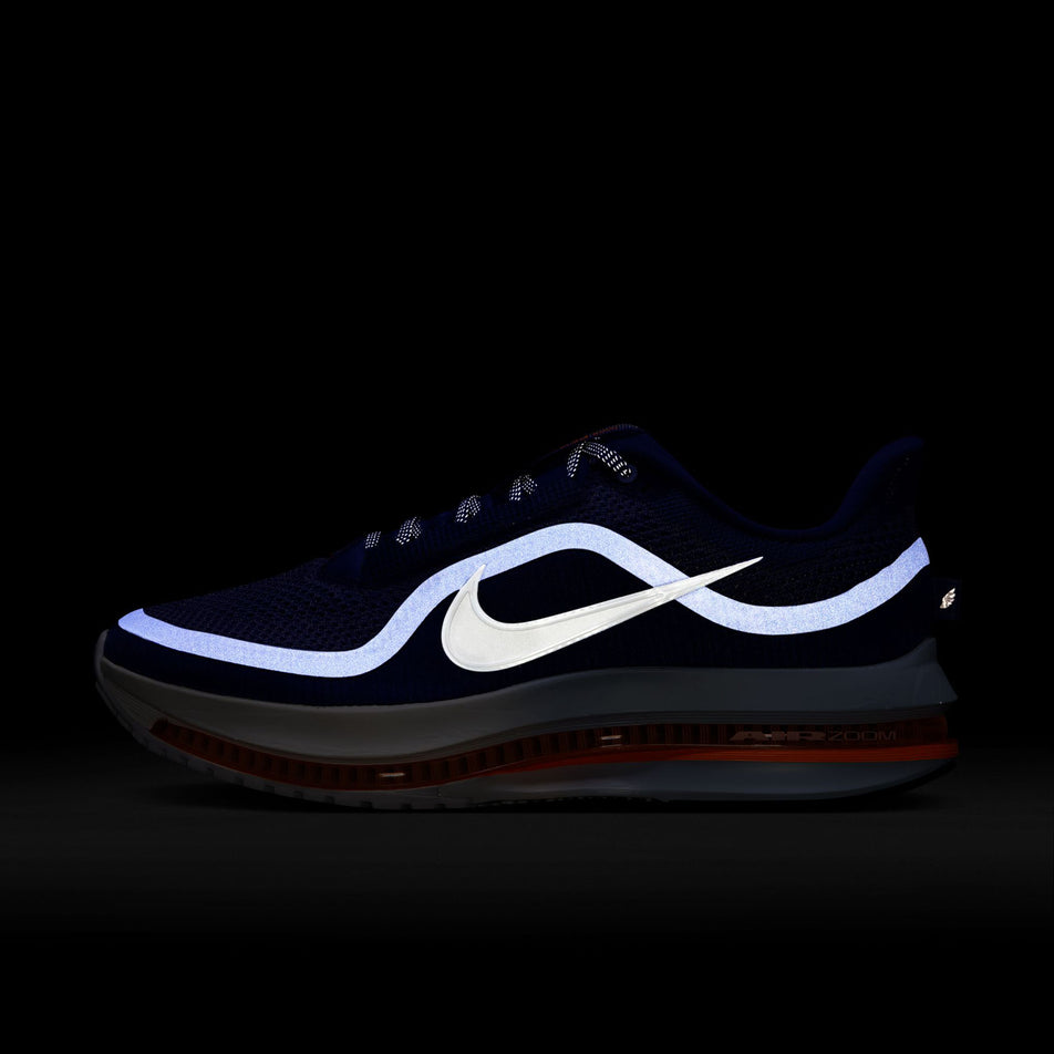 The reflective graphics on the left shoe from a pair of Nike Men's Pegasus Premium Road Running Shoes in the Lapis/White-Total Orange-Off Noir colourway.