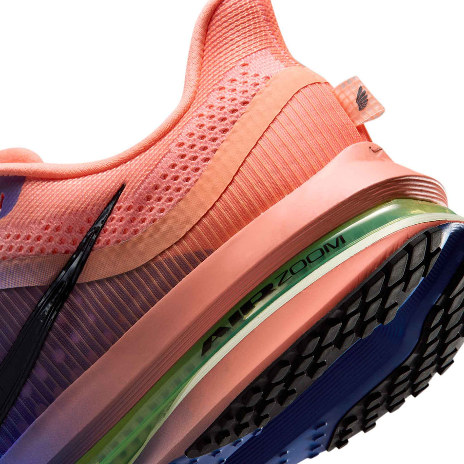 Close-up view of the rearfoot section of the left shoe from a pair of Nike Men's Pegasus Premium Road Running Shoes in the Racer Blue/Black-Atomic Pink-Volt Tint colourway.