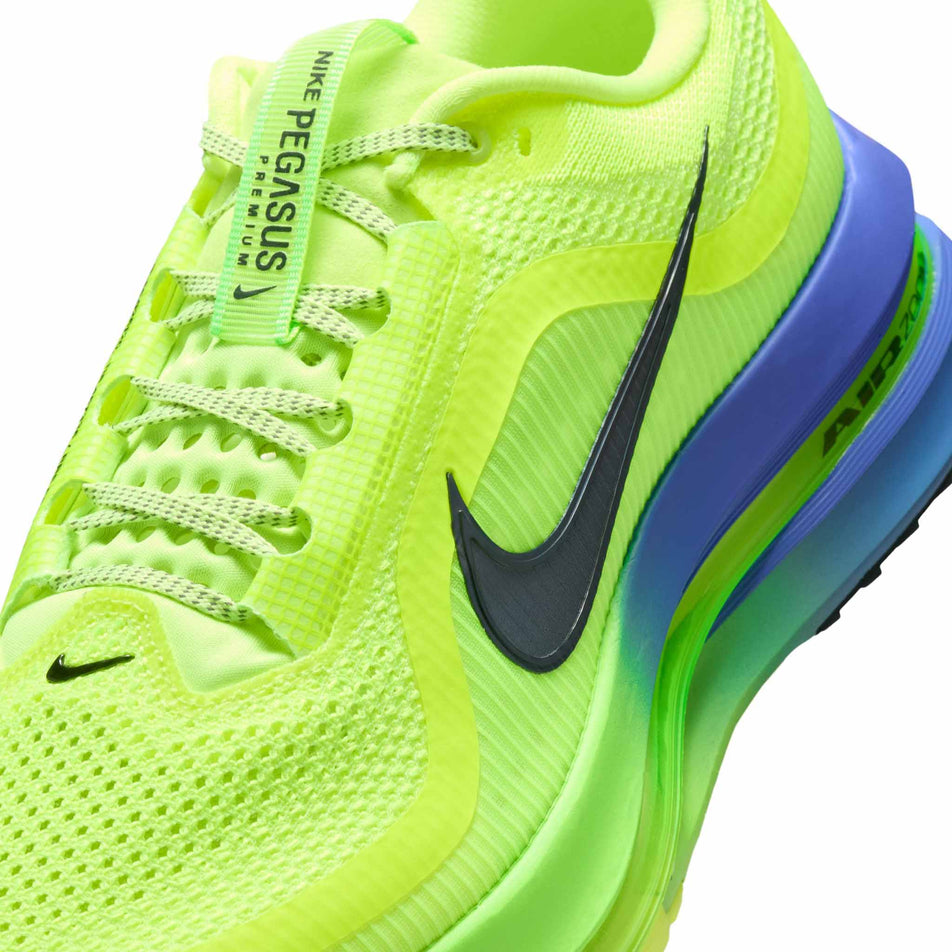 Close-up view of the upper of the left shoe from a pair of Nike Men's Pegasus Premium Road Running Shoes in the Volt Ice/Black Spruce-Lime Blast colourway.