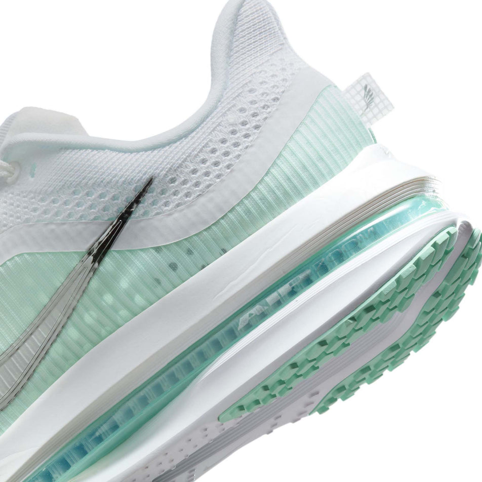 Close up of the midsole of the left shoe from a pair of Nike Women's Pegasus Premium Road Running Shoes in the White/Metallic Silver-Mint Foam-Cannon colourway. (8684688933026)