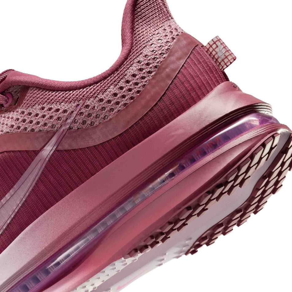 Close-up view of the rearfoot section of the left shoe from a pair of Nike Women's Pegasus Premium Road Running Shoes in the Pink Smoke/Pink Smoke-Light Magenta colourway.