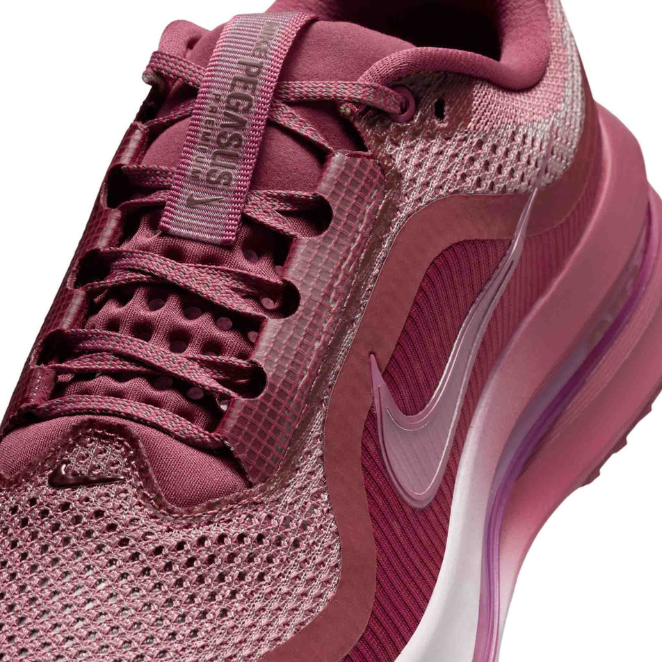 Close-up view of the upper of the left shoe from a pair of Nike Women's Pegasus Premium Road Running Shoes in the Pink Smoke/Pink Smoke-Light Magenta colourway.