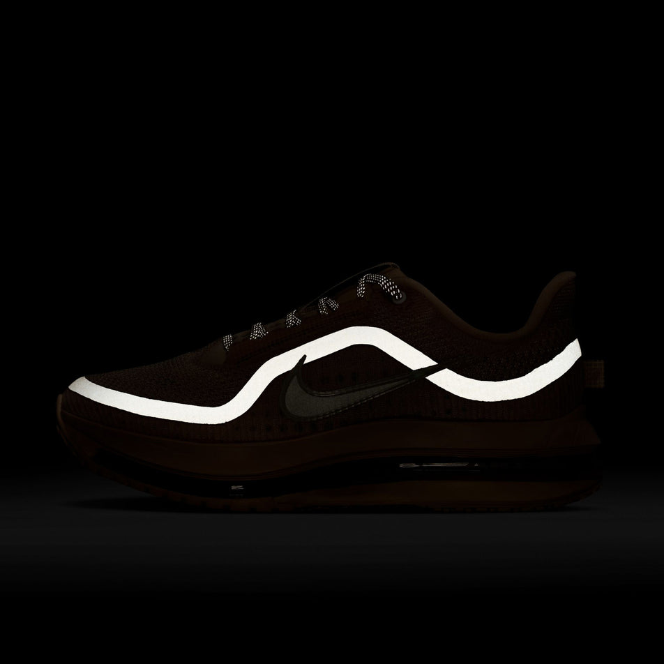 The reflective graphic on the lateral side of the left shoe from a pair of Nike Women's Pegasus Premium Road Running Shoes in the Guava Ice/Sail-Particle Pink colourway.