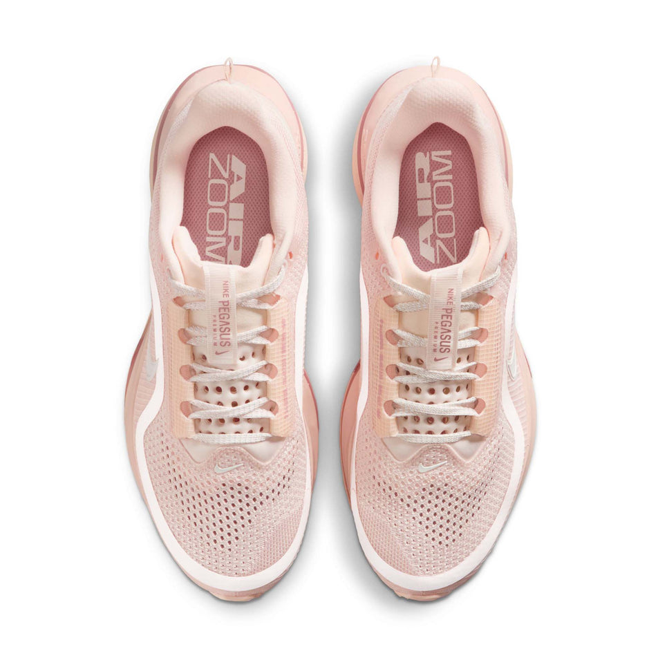 The uppers of a pair of Nike Women's Pegasus Premium Road Running Shoes in the Guava Ice/Sail-Particle Pink colourway.