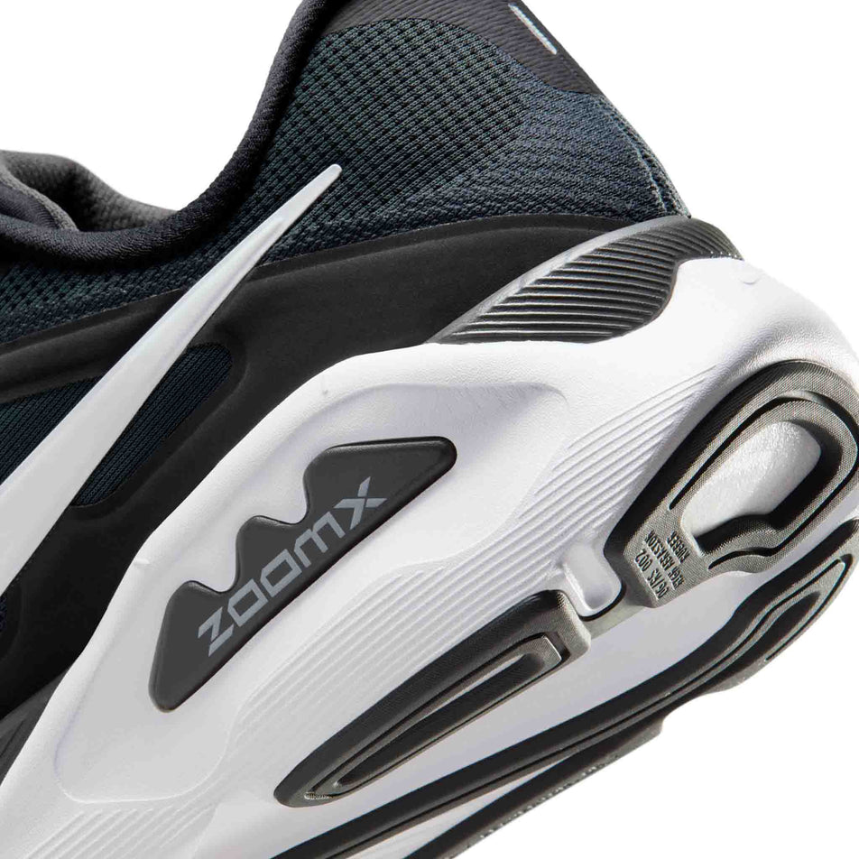 Close-up view of the rearfoot section of the left shoe from a pair of Nike Men's Structure Plus Road Running Shoes in the Black/White-Anthracite colourway.