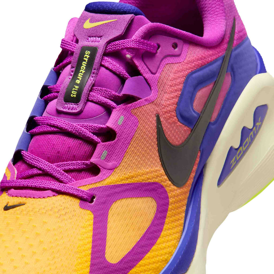 Close-up view of the upper of the left shoe from a pair of Nike Men's Structure Plus Road Running Shoes in the Hyper Violet/Black-Citron Pulse colourway.