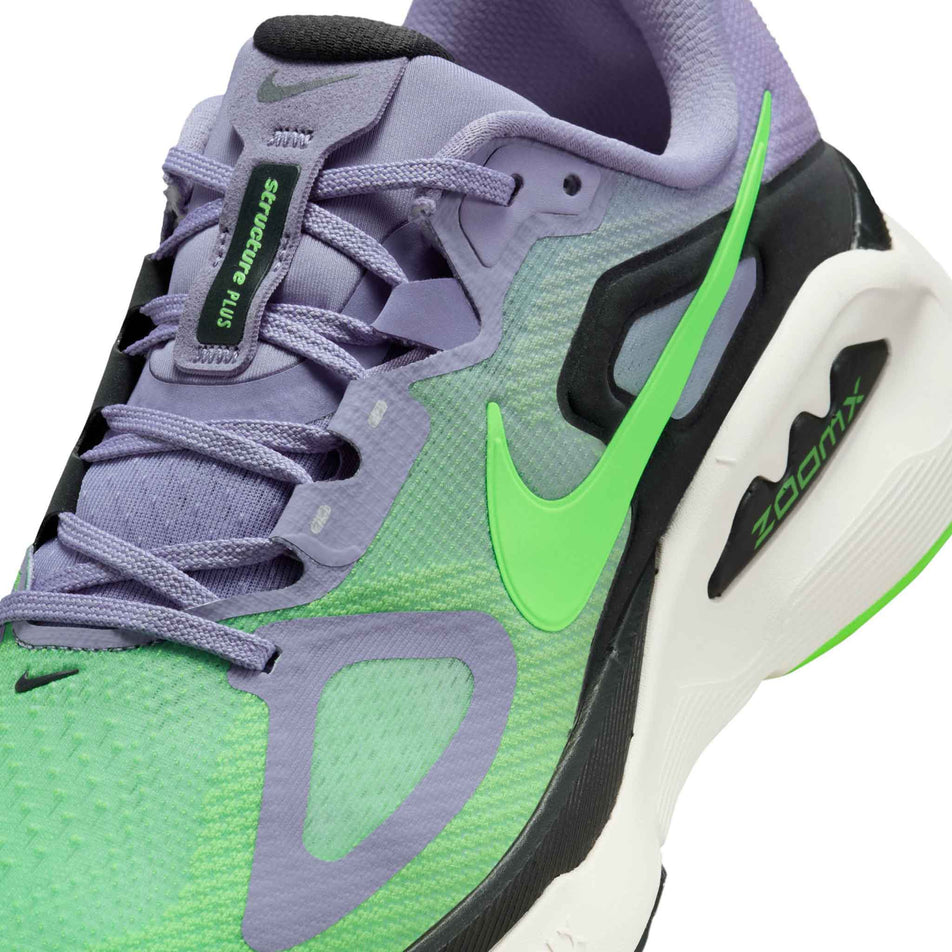 Close-up view of the upper of the left shoe from a pair of Nike Men's Structure Plus Road Running Shoes in the Iron Purple/Voltage Green-Off Noir-Sail colourway.