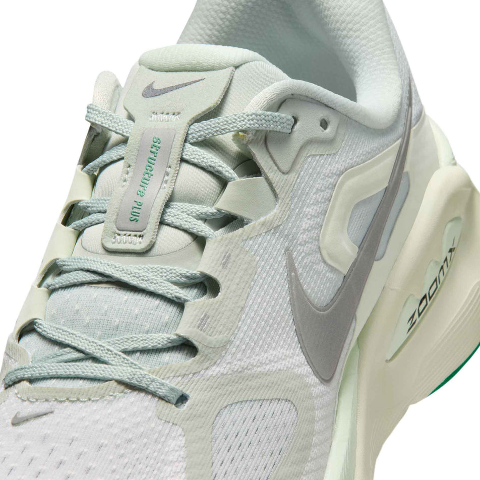 Close-up view of the left shoe from a pair of Nike Women's Structure Plus Road Running Shoes in the Light Silver/Metallic Silver colourway.