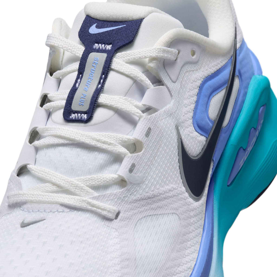 Close-up view of the upper of the left shoe from a pair of Nike Women's Structure Plus Road Running Shoes in the White/Midnight Navy-Royal Pulse colourway.