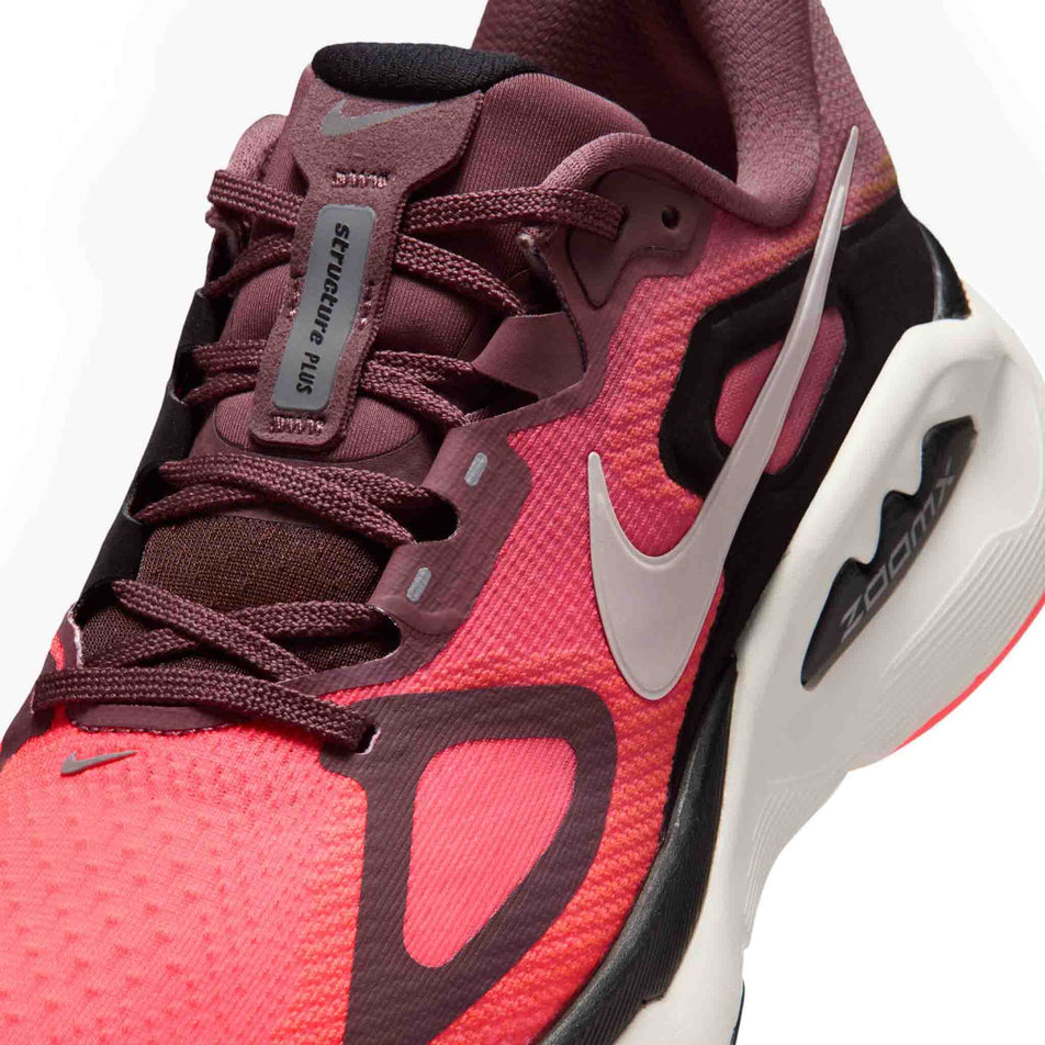 Close-up view of the upper of the left shoe from a pair of Nike Women's Structure Plus Road Running Shoes in the Tattoo/Silver-Hot Lava-Black colourway.