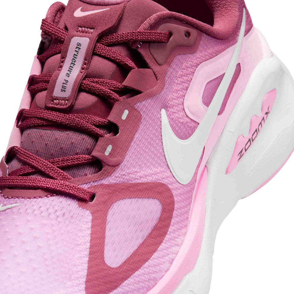 Close-up view of the upper of the left shoe from a pair of Nike Women's Structure Plus Road Running Shoes in the Pink Smoke/White-Pink Rise-Light Magenta colourway.