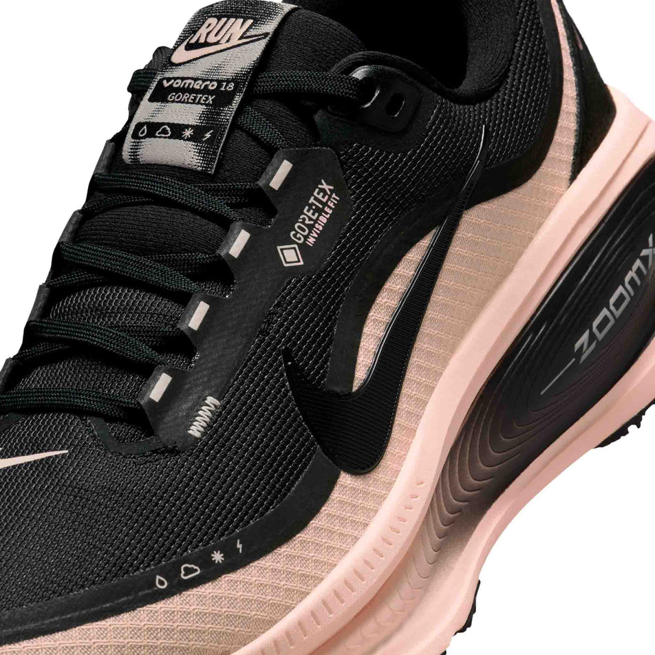 Close-up view of the upper of the left shoe from a pair of Nike Women's Vomero 18 GORE-TEX Road Running Shoes in the Black/Black-Crimson Tint-Black colourway. (8756162494626)