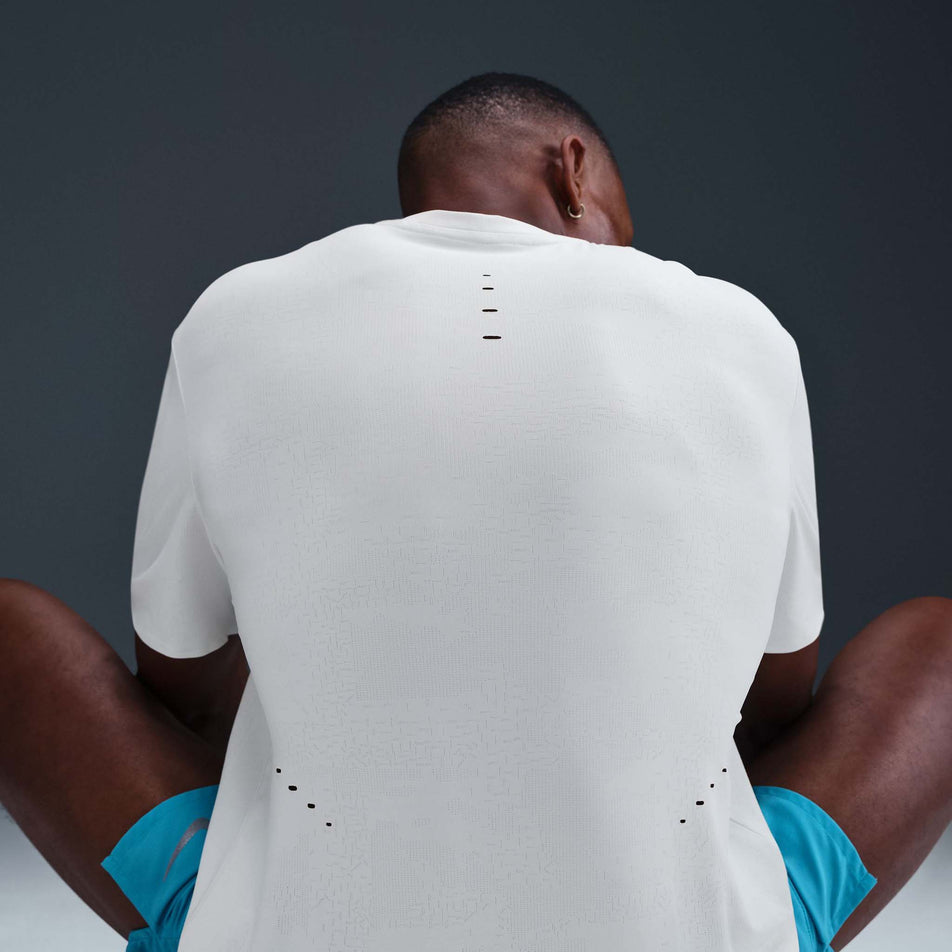 Back view of a model wearing the Nike Men's Dri-FIT ADV Run Pinnacle Short-Sleeve Running Top in the Summit White/Blkref colourway. (8710821314722)