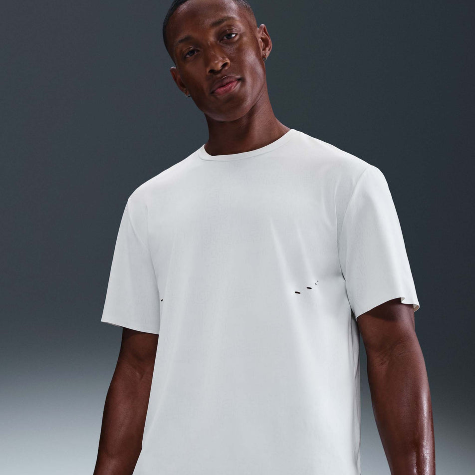 Front view of a model wearing the Nike Men's Dri-FIT ADV Run Pinnacle Short-Sleeve Running Top in the Summit White/Blkref colourway. (8710821314722)