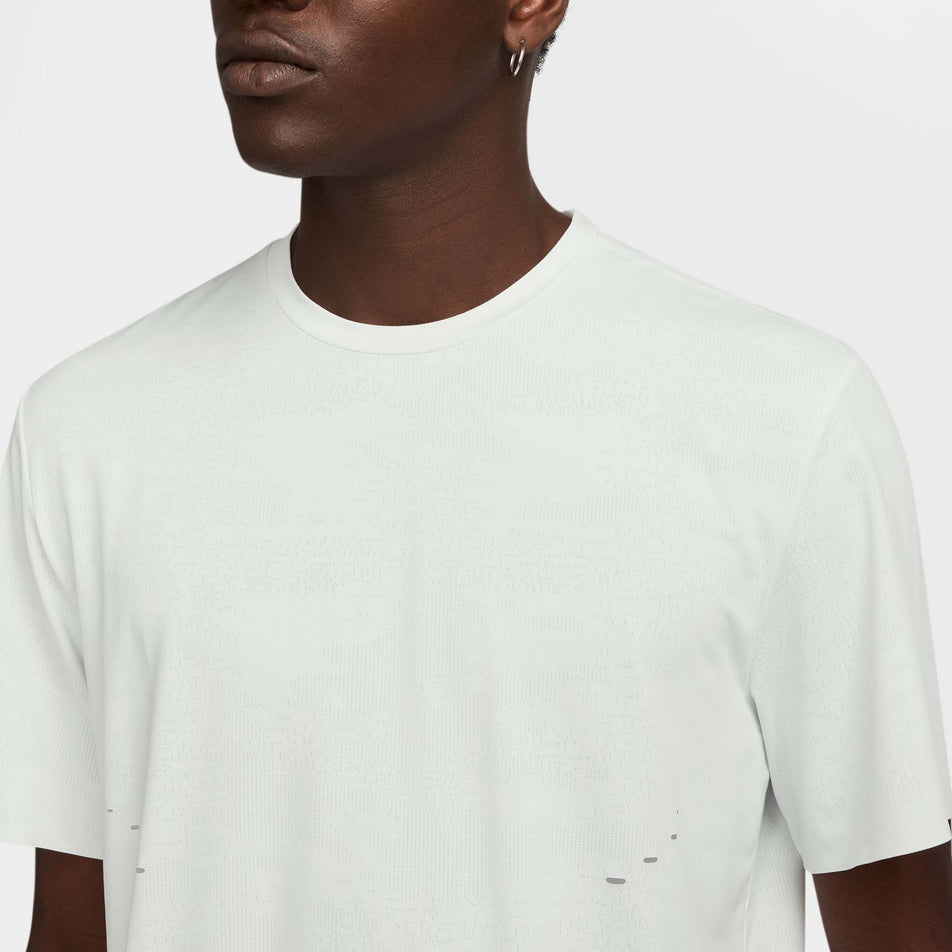 Front view of a model wearing the Nike Men's Dri-FIT ADV Run Pinnacle Short-Sleeve Running Top in the Summit White/Blkref colourway. (8710821314722)