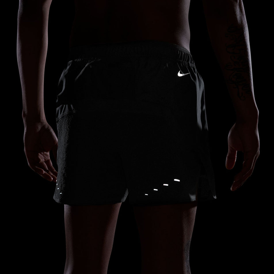 The reflective Nike Swoosh and pills on the back of the Nike  Men's Dri-FIT ADV 5