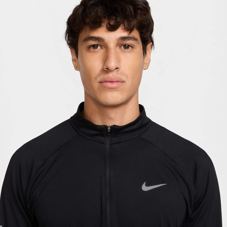 Front view of a model wearing the Nike Men's Stride Dri-FIT 1/4-Zip Running Top in the Black/Reflective Silver colourway. (8778198876322)
