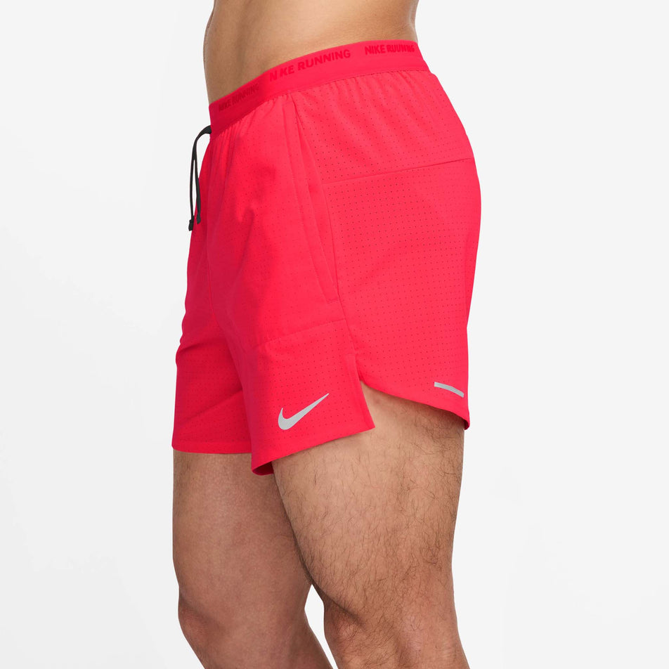 Side view of a model wearing the Nike Men's Stride Dri-FIT 5