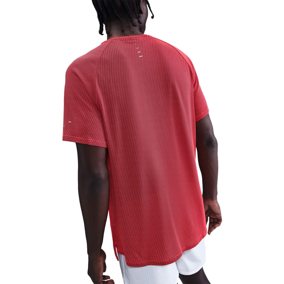 Back view of a model wearing the Nike Men's Dri-FIT Stride Jacquard Short-Sleeve Running Top in the Bright Crimson/Reflective Silver colourway. (8716724895906)