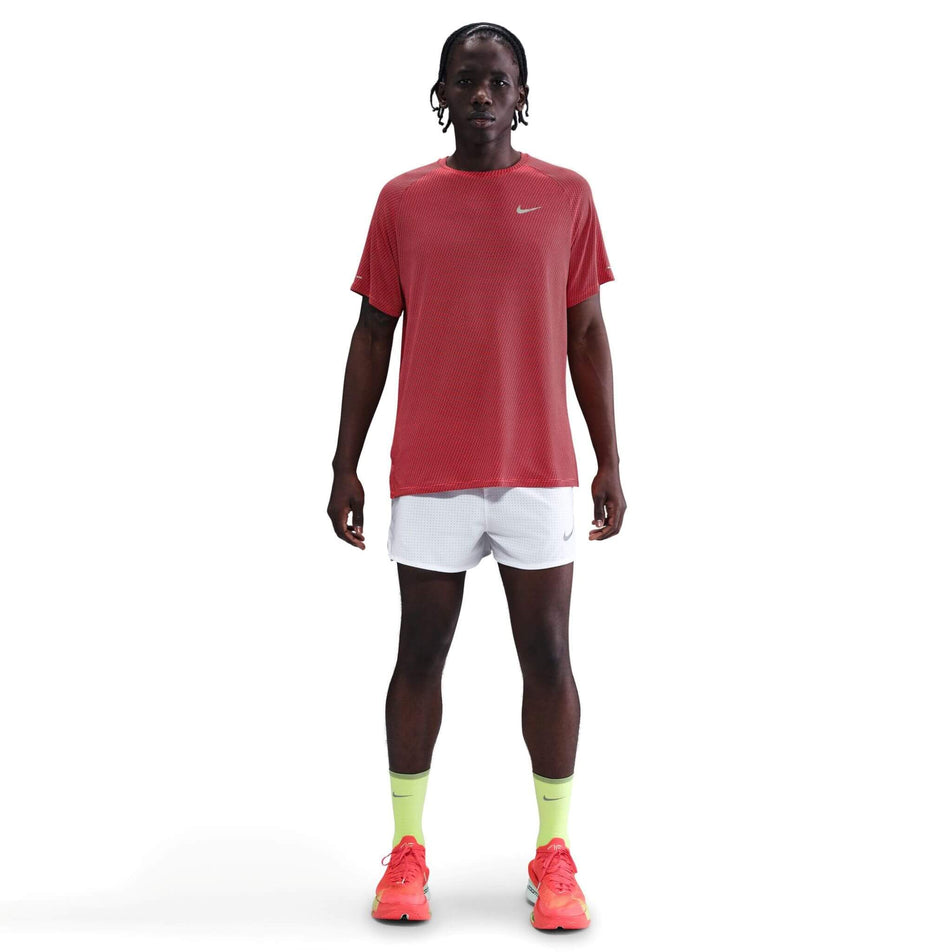 Front view of a model wearing the Nike Men's Dri-FIT Stride Jacquard Short-Sleeve Running Top in the Bright Crimson/Reflective Silver colourway. (8716724895906)