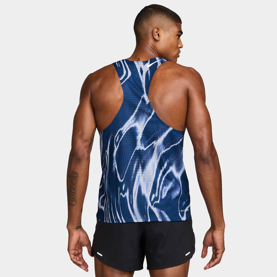 Back view of a model wearing the Nike Men's AeroSwift Dri-FIT ADV Running Singlet in the Coastal Blue/White colourway. (8710427803810)