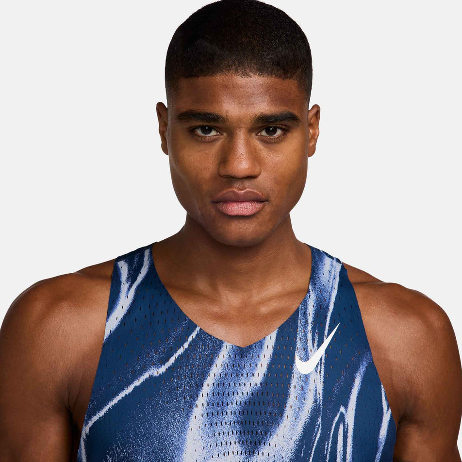 Front view of a model wearing the Nike Men's AeroSwift Dri-FIT ADV Running Singlet in the Coastal Blue/White colourway. (8710427803810)