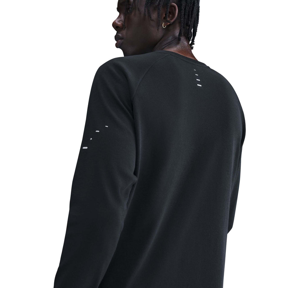 Back view of a model wearing the Nike Men's Dri-FIT Stride Running Waffle Crew in the Black/Reflective Silver colourway. (8733246980258)