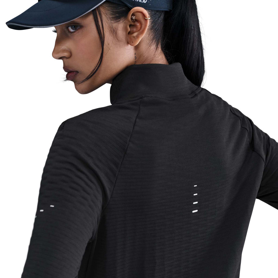 Back view of the Nike Women's Swift Therma-FIT Turtle-Neck Running Top in the Black/Reflective Silver colourway. (8756579270818)