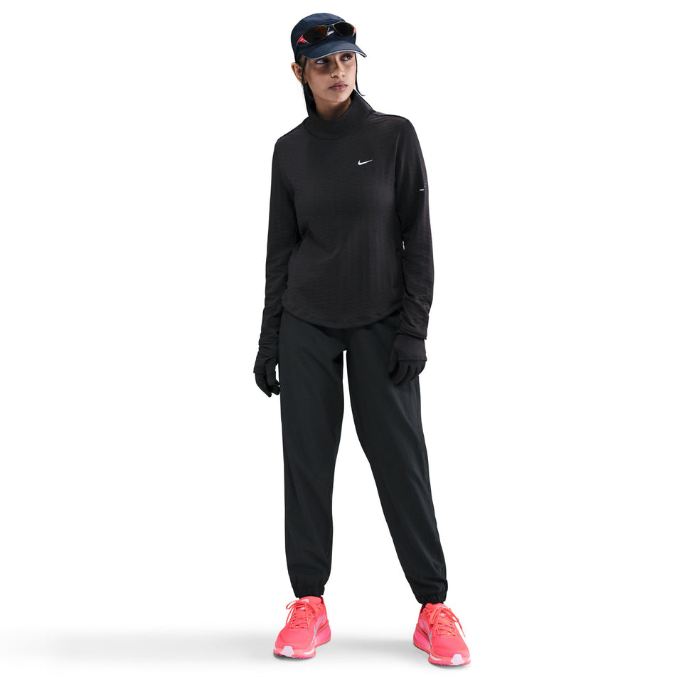 Front view of the Nike Women's Swift Therma-FIT Turtle-Neck Running Top in the Black/Reflective Silver colourway. (8756579270818)