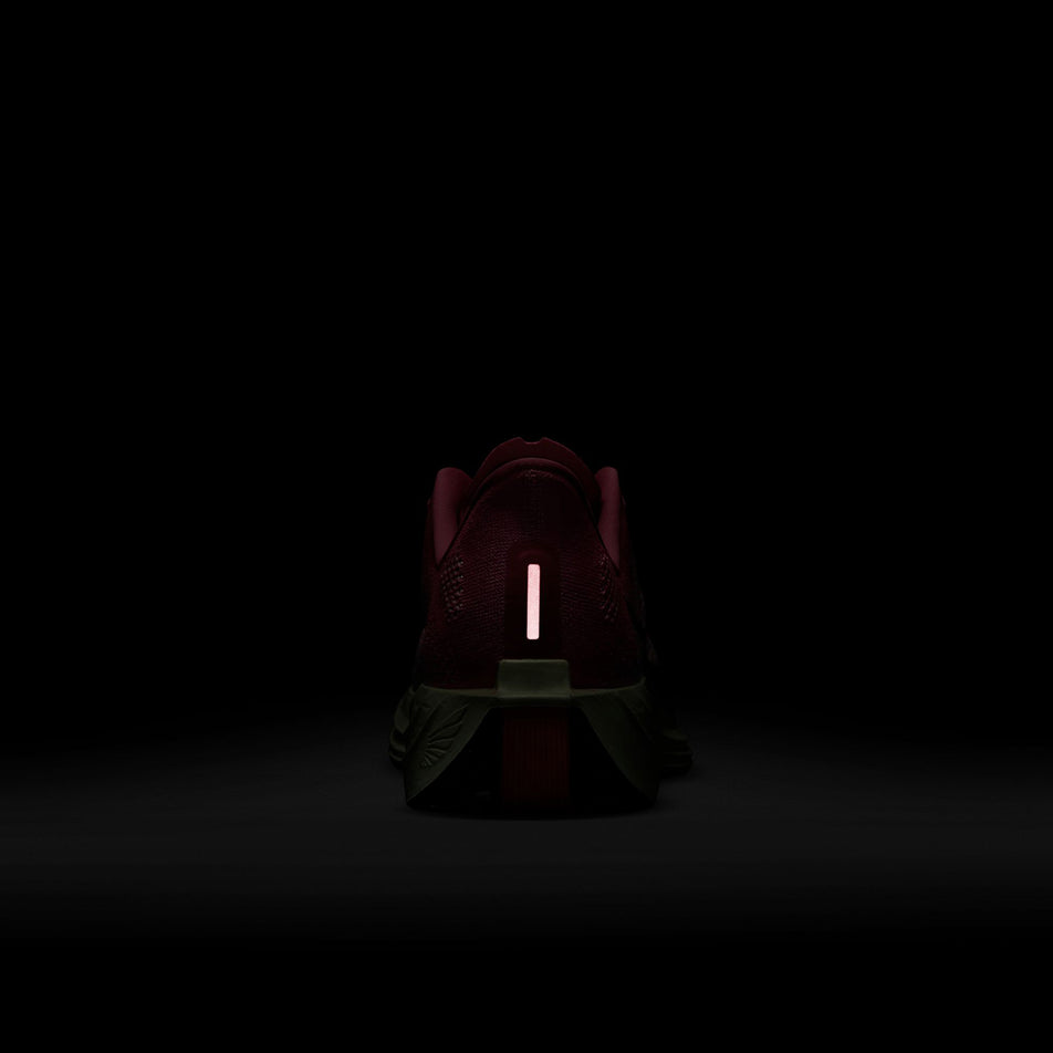 The reflective detail on the back of the left shoe from a pair of Nike Men's Pegasus Plus Road Running Shoes in the Hyper Pink/Sequoia-Bright Crimson colourway. (8614436044962)