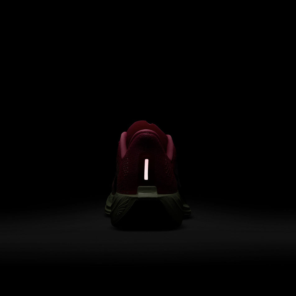 The reflective strip on the back of the right shoe from a pair of Nike Women's Pegasus Plus Road Running Shoes in the Hyper Pink/Sequoia-Bright Crimson colourway. (8615305871522)