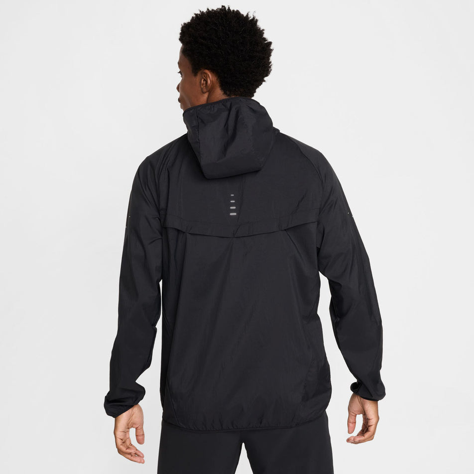 Back view of a model wearing the Nike Men's Stride Repel UV Running Jacket in the Black/Black/Reflective Silver colourway.