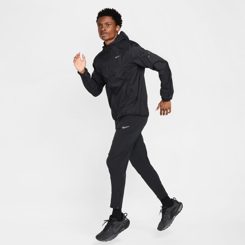 Front view of a model wearing the Nike Men's Stride Repel UV Running Jacket in the Black/Black/Reflective Silver colourway.