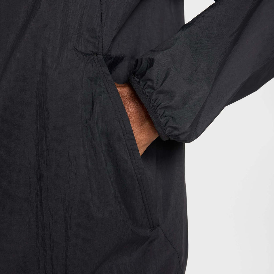 The pocket on the side of the Nike Men's Stride Repel UV Running Jacket in the Black/Black/Reflective Silver colourway.