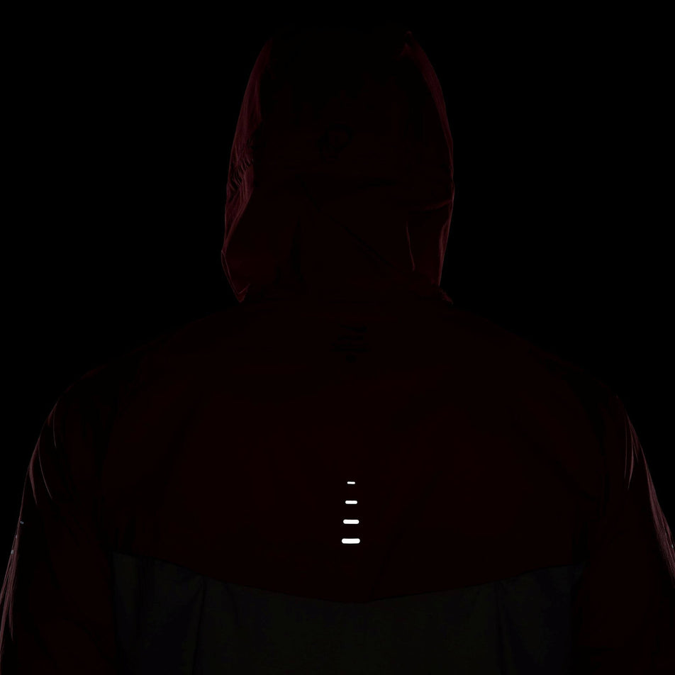The back reflectivity on a Nike Men's Stride Repel UV Running Jacket in the University Red/Reflective Silver colourway. Jacket is being worn by a model. (8591132655778)
