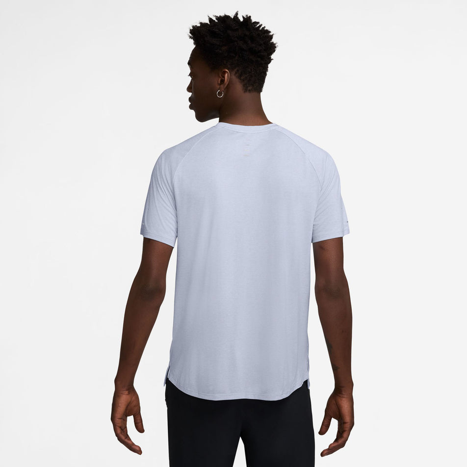 Back view of a model wearing the Nike Men's Stride Dri-FIT ADV Short-Sleeve Running Top in the Ghost/Heather/Reflective Silver colourway. (8710942458018)