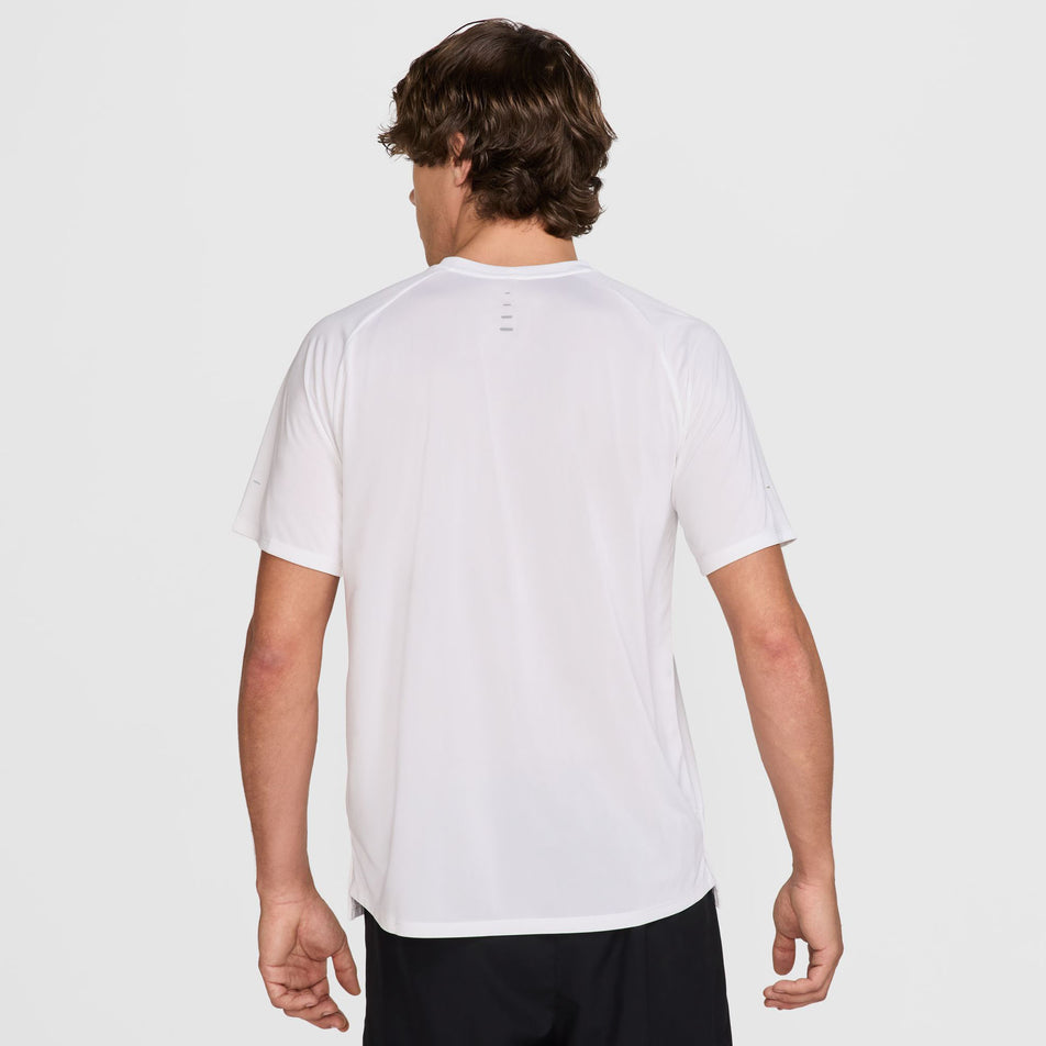 Back view of a model wearing the Nike Men's Stride Dri-FIT ADV Short-Sleeve Running Top in the White/Reflective Silver colourway. (8620699844770)