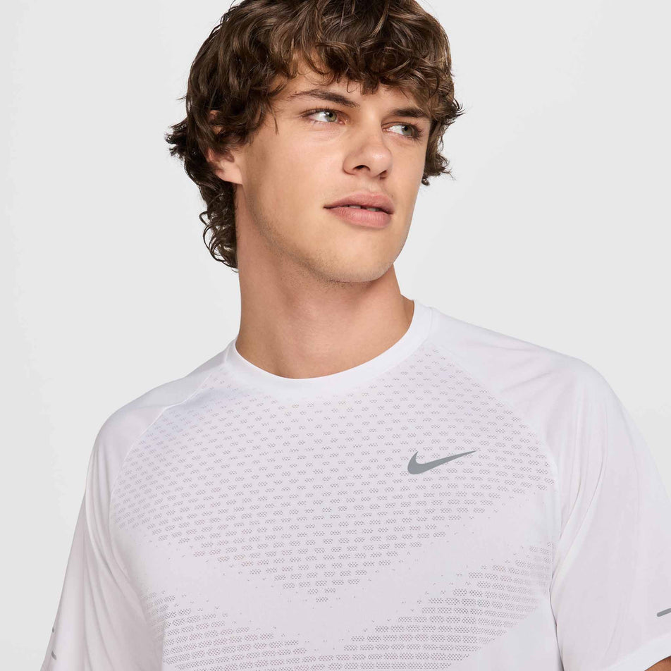 Front view of a model wearing the Nike Men's Stride Dri-FIT ADV Short-Sleeve Running Top in the White/Reflective Silver colourway. (8620699844770)