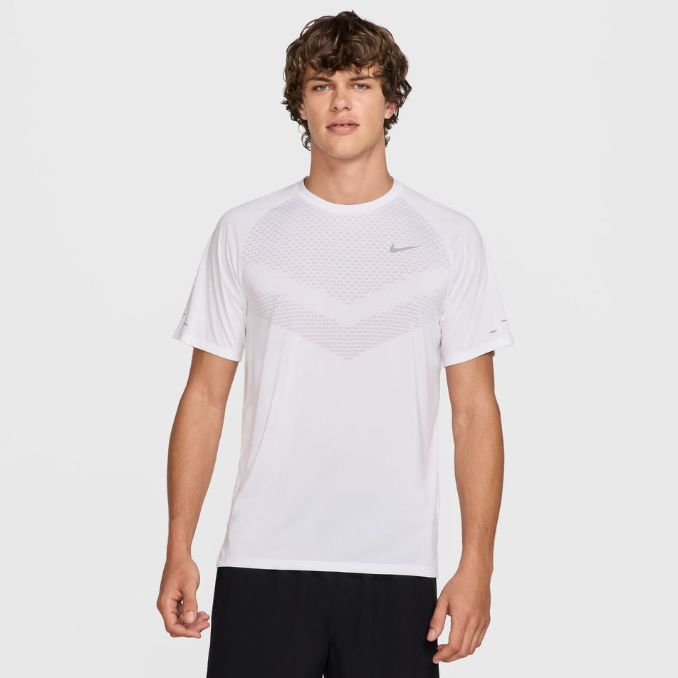 Front view of a model wearing the Nike Men's Stride Dri-FIT ADV Short-Sleeve Running Top in the White/Reflective Silver colourway. (8620699844770)