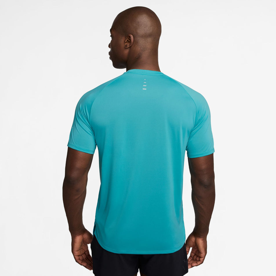 Back view of a model wearing the Nike Men's Stride Dri-FIT ADV Short-Sleeve Running Top in the Dusty Cactus/Reflective Silver colourway. (8562852823202)