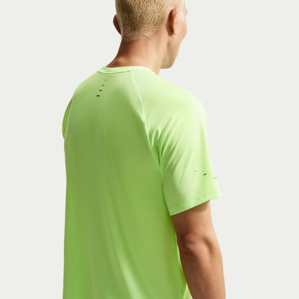 Back view of a model wearing the Nike Men's Stride Dri-FIT ADV Short-Sleeve Running Top in the Lime Blast/Reflective Silver colourway.